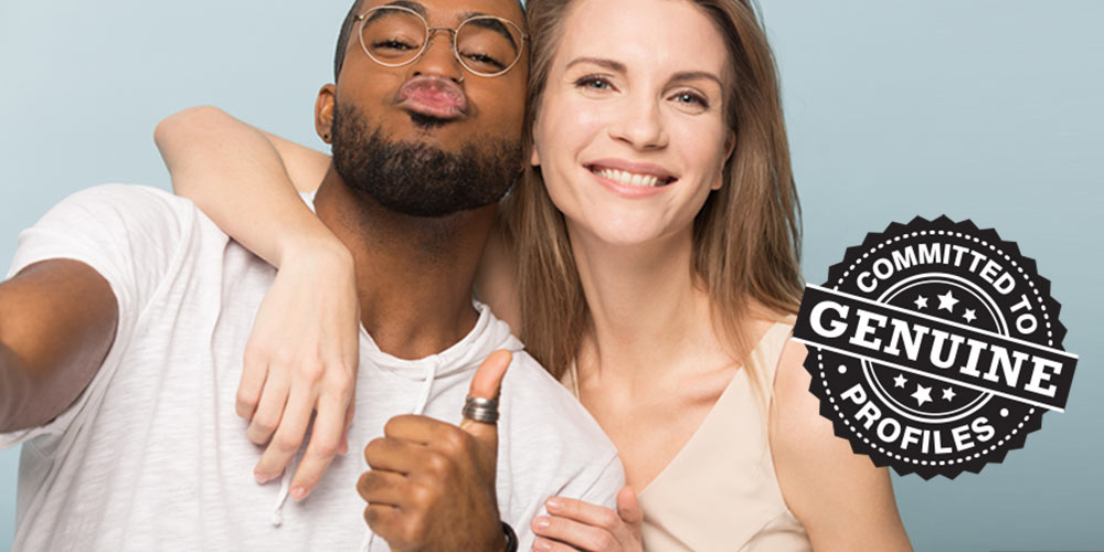 Interracial couple displaying thumbs up sign to show they are genuine