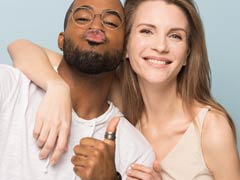 Interracial couple displaying thumbs up sign