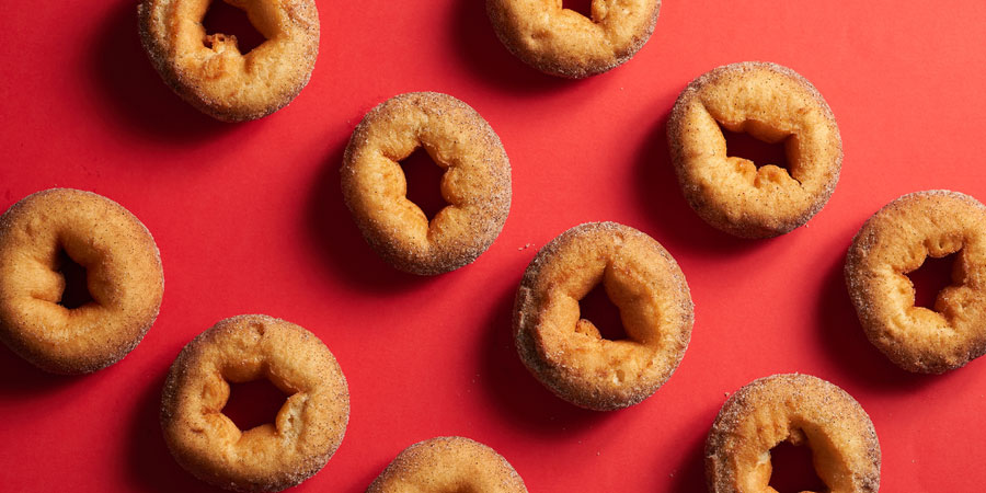 Cinnamon donuts displayed on a red table 