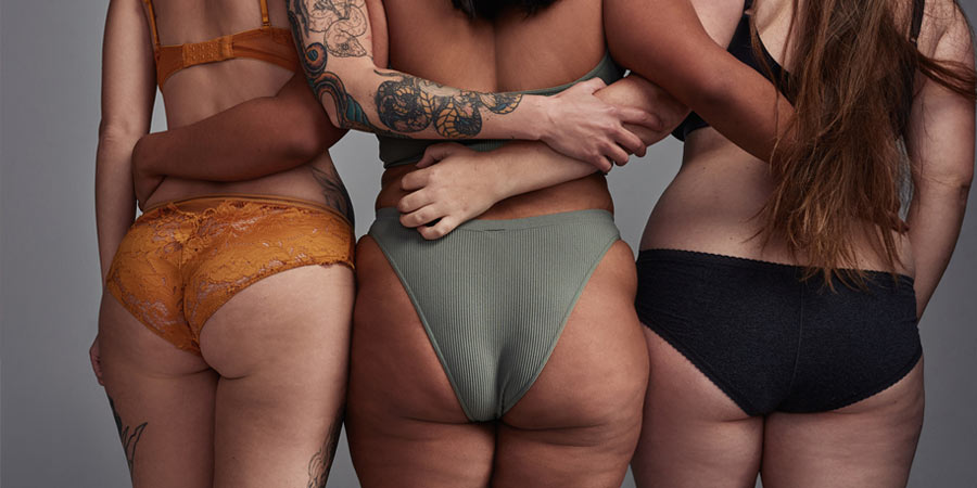 Rear view of three curvy women wearing lingerie 