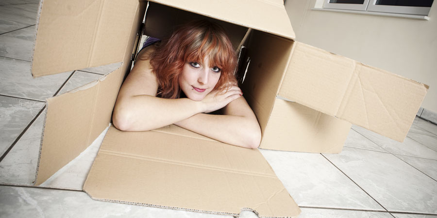 Woman inside a cardboard box