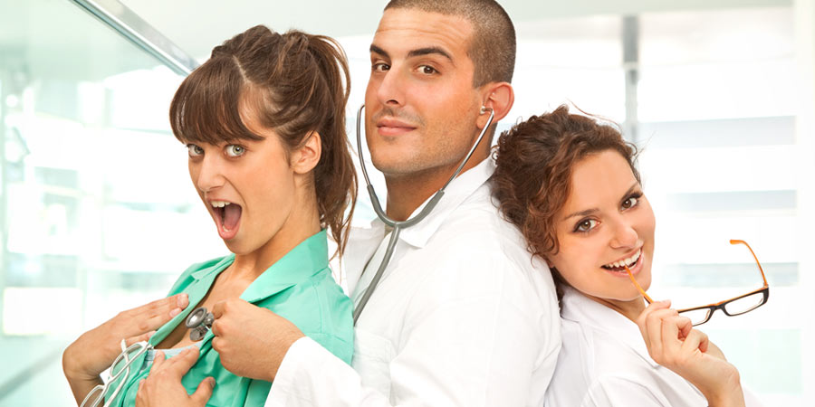 Two women dresses as nurses and a man with a stethoscope doing medical fetish roleplay